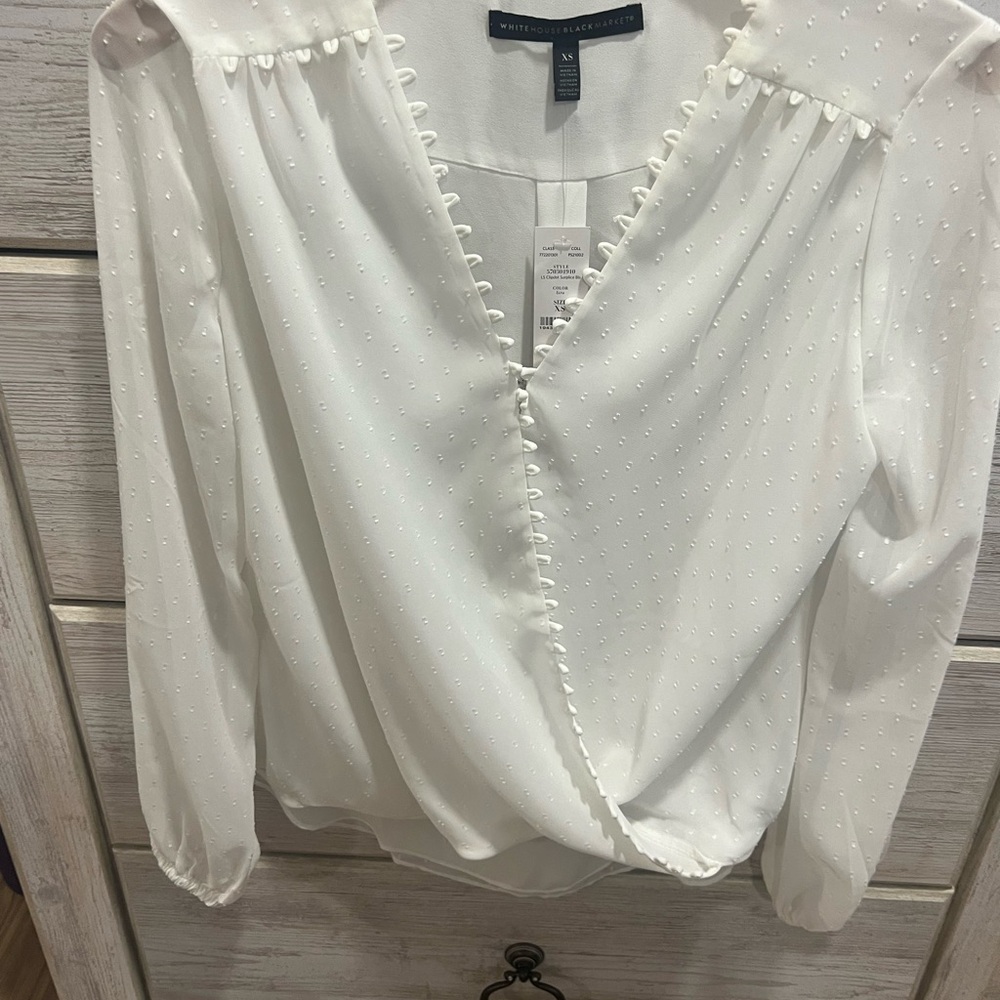 White House Black Market v-neck blouse in white. color is called Ecru.